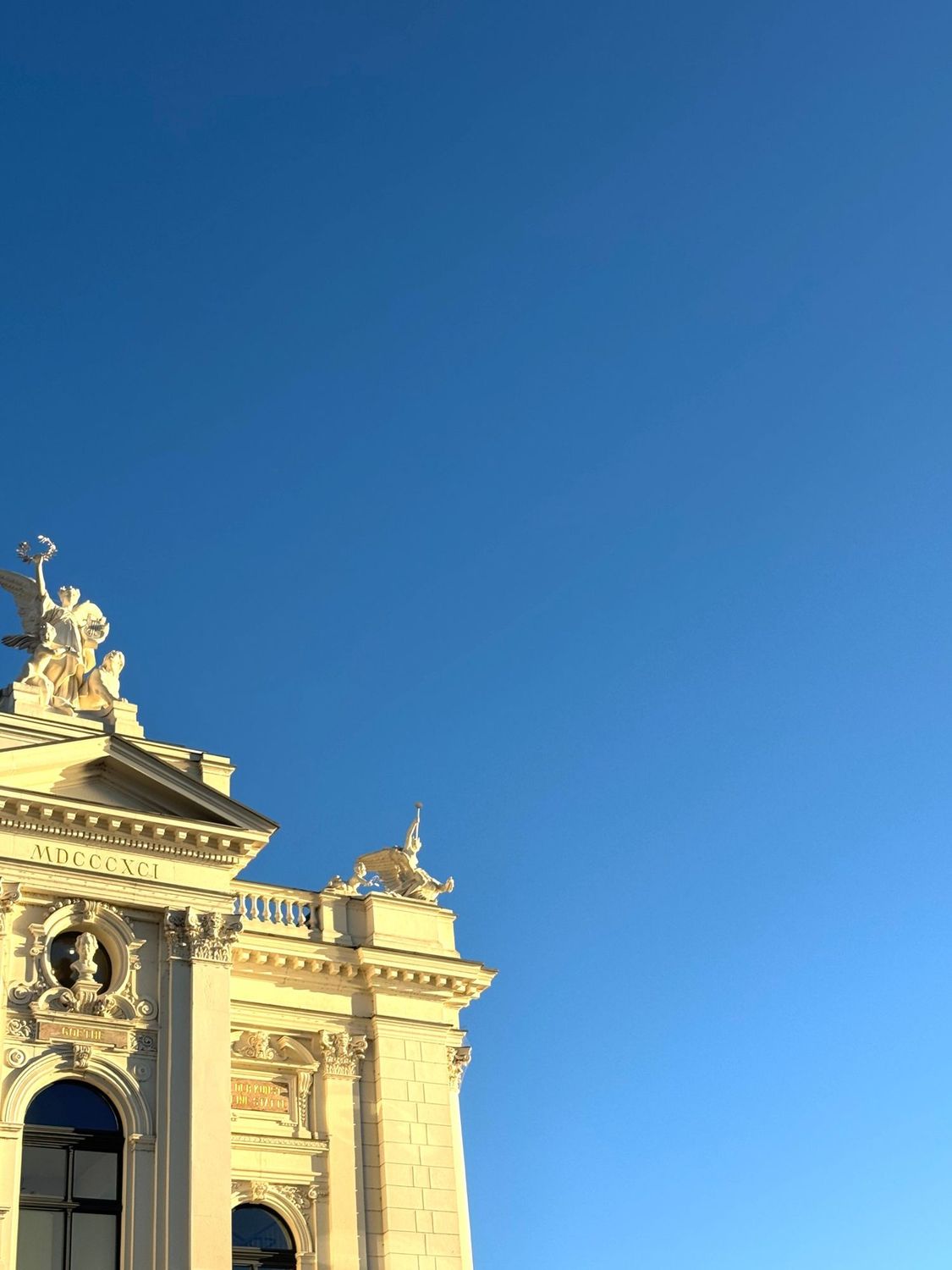 The Opernhaus Zürich façade and its sculpted muses in late afternoon light