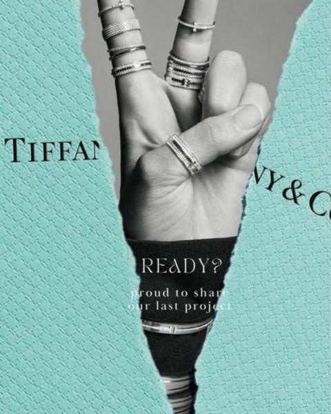 Invitation design for Tiffany & Co.: a hand stacked with Tiffany rings revealed through torn Tiffany Blue paper